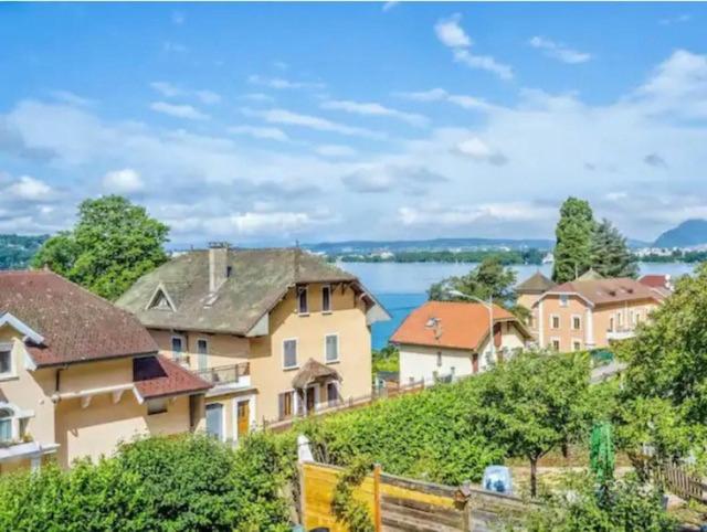 un groupe de maisons sur une colline avec une masse d'eau dans l'établissement Loft Veyrier, à Veyrier-du-Lac