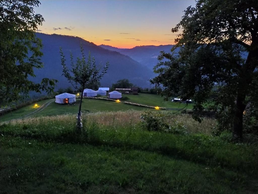 a group of tents in a field at sunset at Yurte in Langa in Bosia