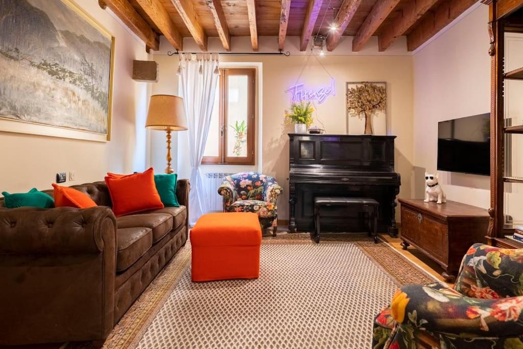 a living room with a couch and a piano at Diladdarno-Florence style APT in Florence