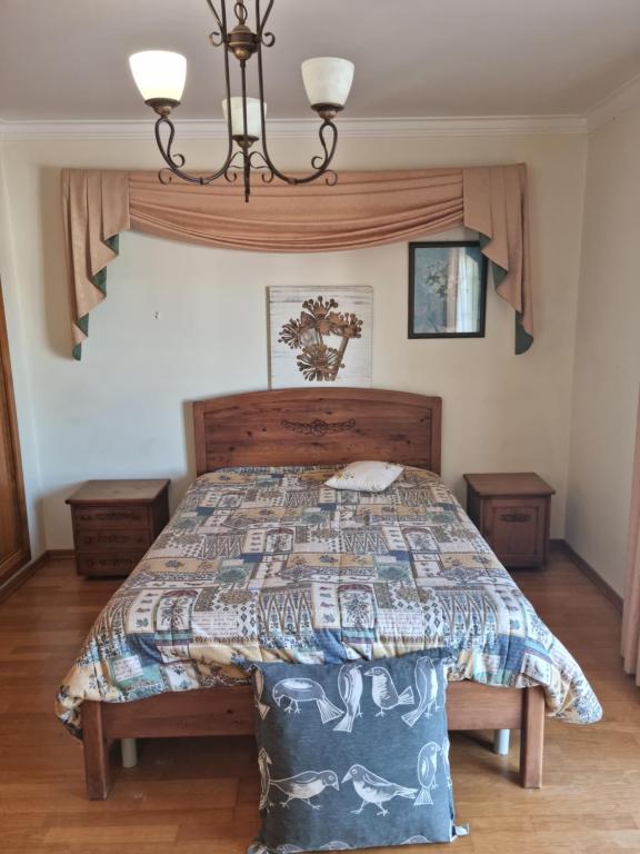 a bedroom with a bed with a quilt on it at Serra e Mar Ferragudo in Ferragudo