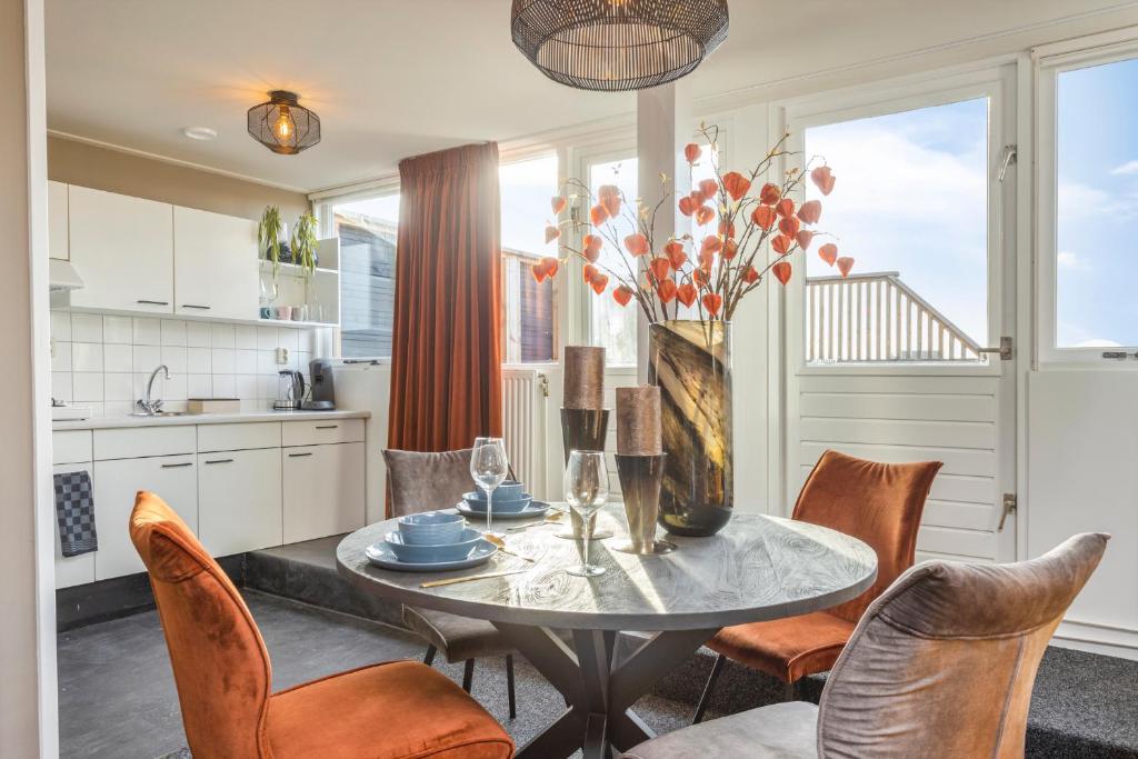 a kitchen and dining room with a table and chairs at Enschede83 in Enschede