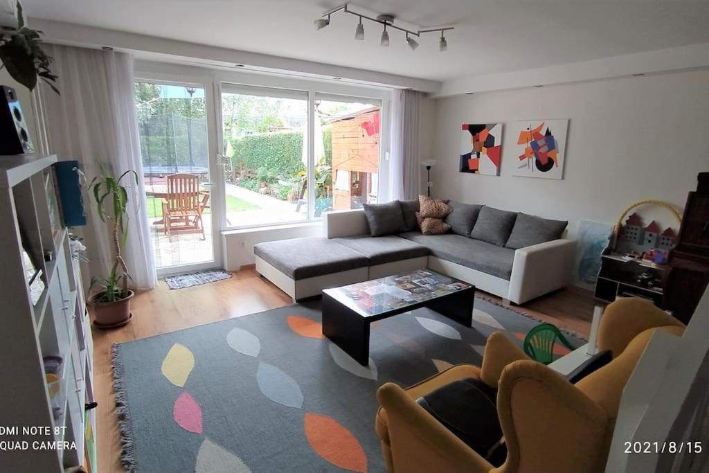 a living room with a couch and a table at Family house by the Sziget festival in Budapest