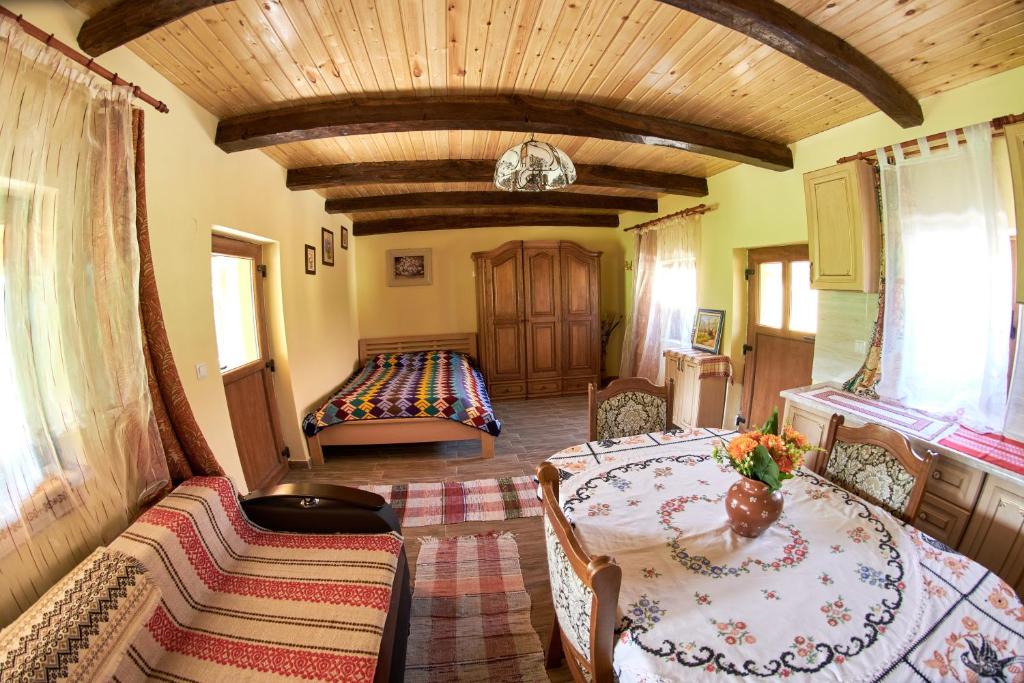 a living room with two tables and a couch at Casa Ciobanca in Vadul lui Carol II