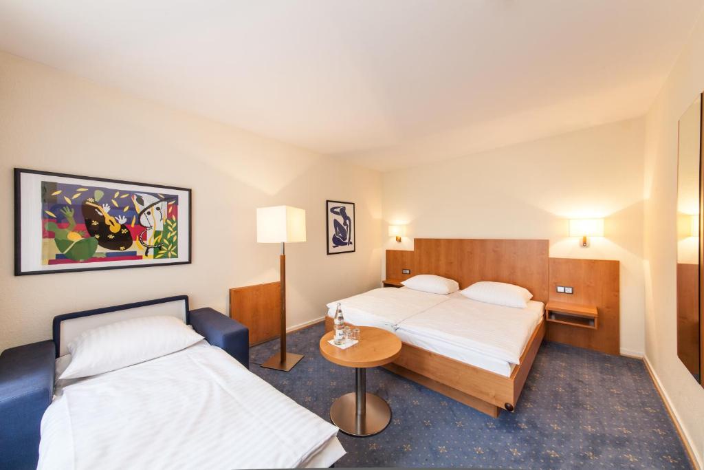 Postel nebo postele na pokoji v ubytování Hotel Drei Kronen Elmshorn
