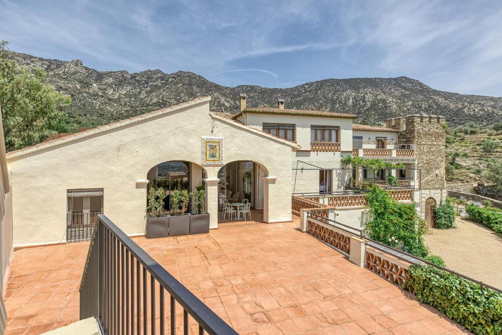 a large house with a balcony with a fence at Mas Cusi in Palau-Saverdera