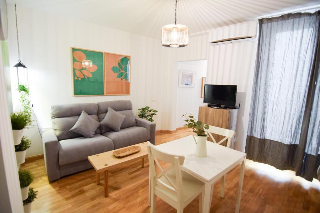 a living room with a couch and a table at Letmalaga Carretería in Málaga