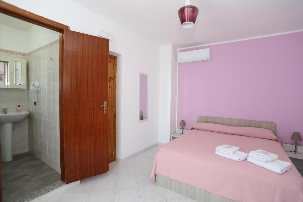 Postel nebo postele na pokoji v ubytování B&B Saracinello