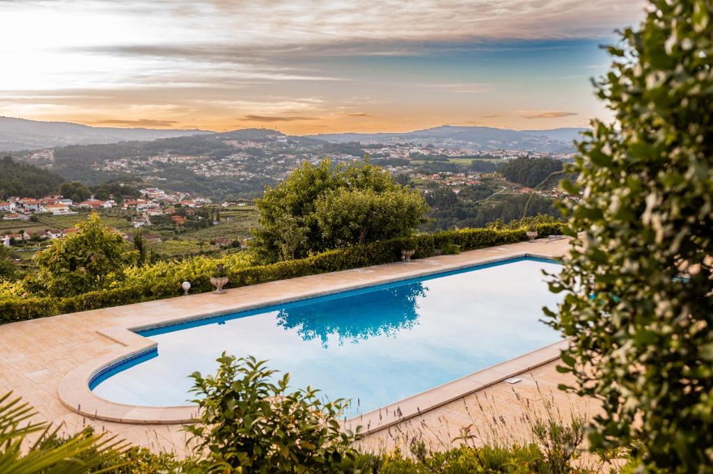a swimming pool in a villa with a view at Casa do Amial in Castelo de Paiva