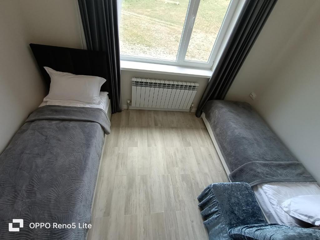 a bedroom with two beds and a window at Hotel Kolsay Eki Agayindy in Kurmenty