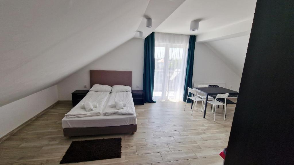 um quarto com uma cama e uma mesa com cadeiras em Gęsi Puch em Gąski