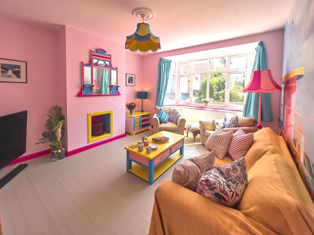 a living room with a couch and a table at Aqua Cottage in Combe Martin