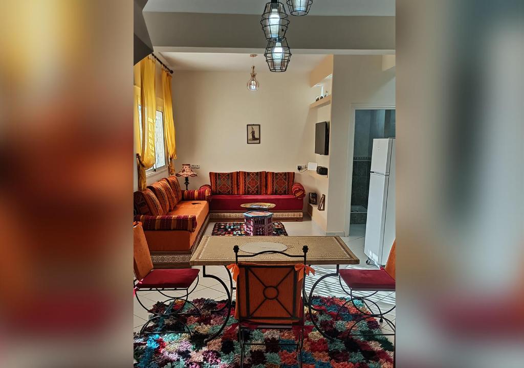 a living room with a couch and a table at appartement julia au centre ville agadir dans résidence borj dalat in Agadir