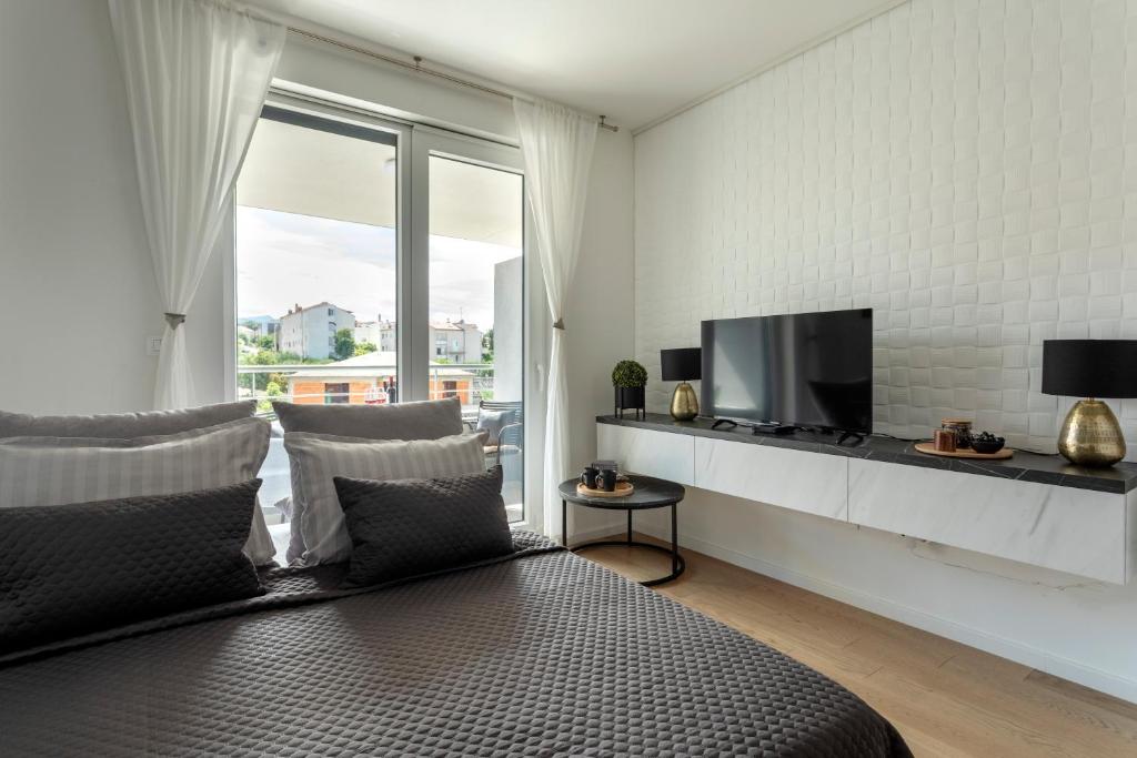a living room with a bed and a tv at Apartman Elena in Split