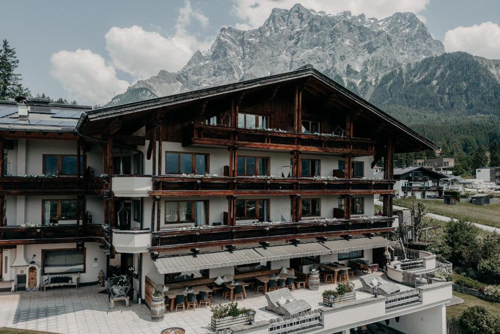 a large building with a mountain in the background at Alpenappartements Cristall in Ehrwald