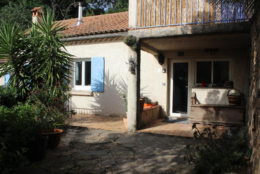 a white house with a door and a patio at Maison La Rascasse in Rayol-Canadel-sur-Mer