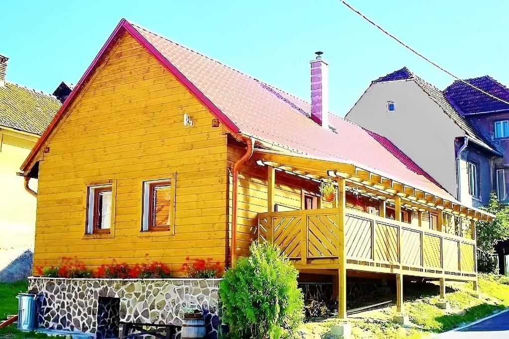 a large wooden house with a red roof at Romantická chalupa pod Vysokými Tatrami in Liptovský Hrádok