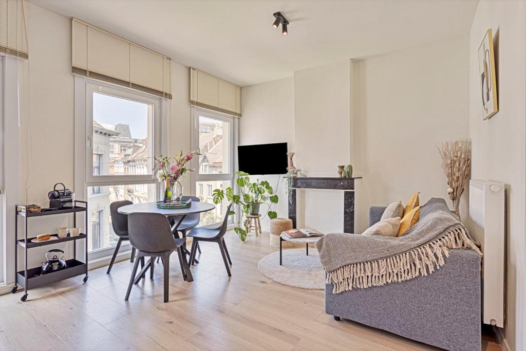 a living room with a couch and a table at New renovated condo's @ trendy south in Antwerp
