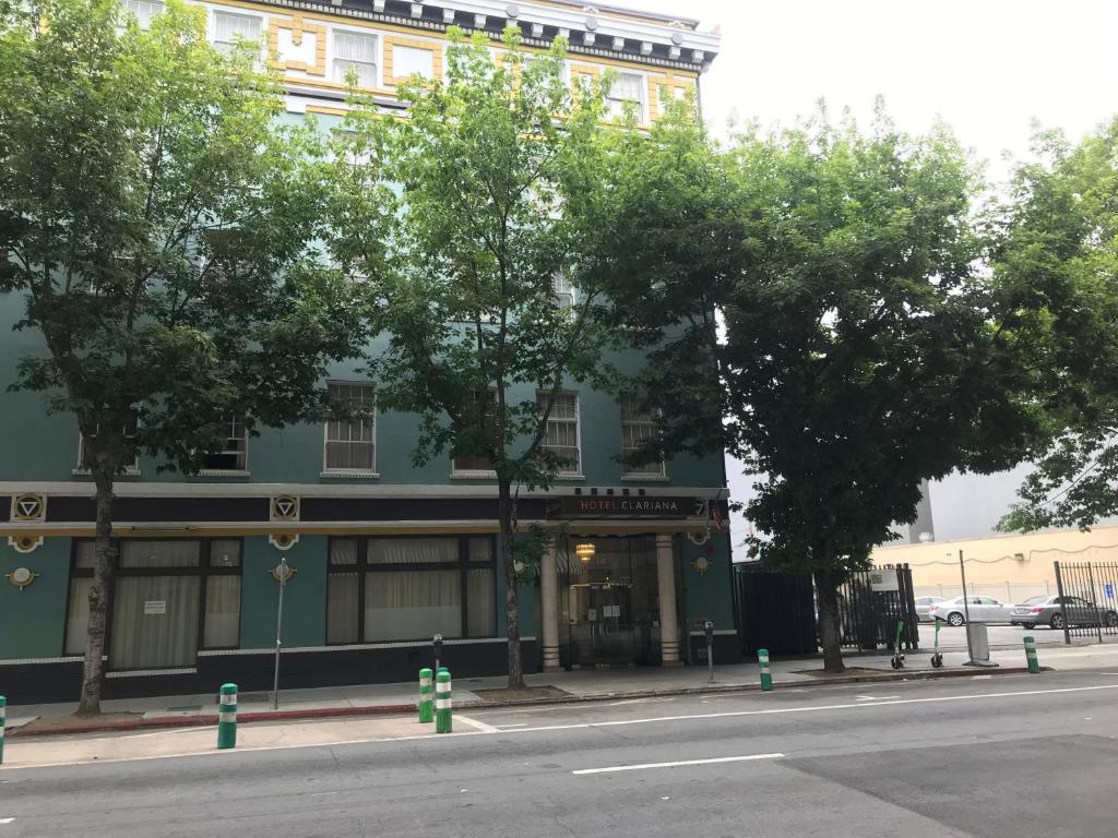 ein grünes Gebäude mit Bäumen vor einer Straße in der Unterkunft Hotel Clariana in San Jose