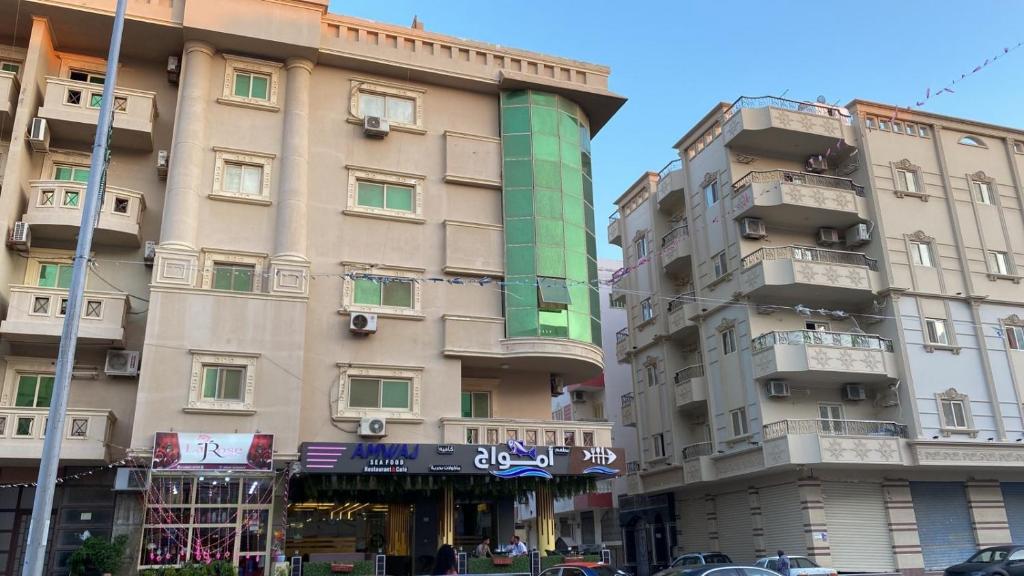 a tall building next to two tall buildings at Amwaj Compound in Hurghada