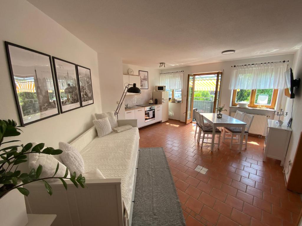 a living room with a white couch and a table at GHR Apartment in Simbach am Inn