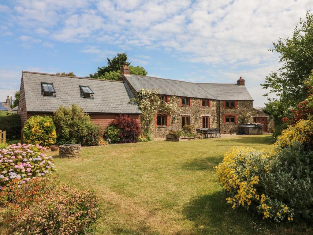 a large brick house with a yard at Varley Lodge in Barnstaple