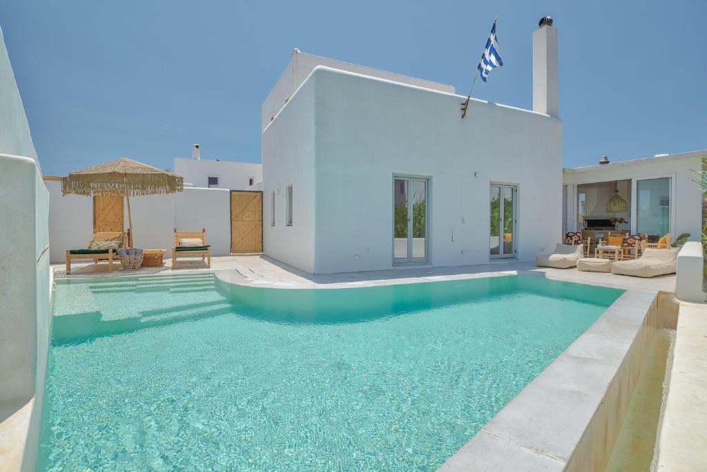 a swimming pool in the middle of a house at Villa Yialos in Antiparos