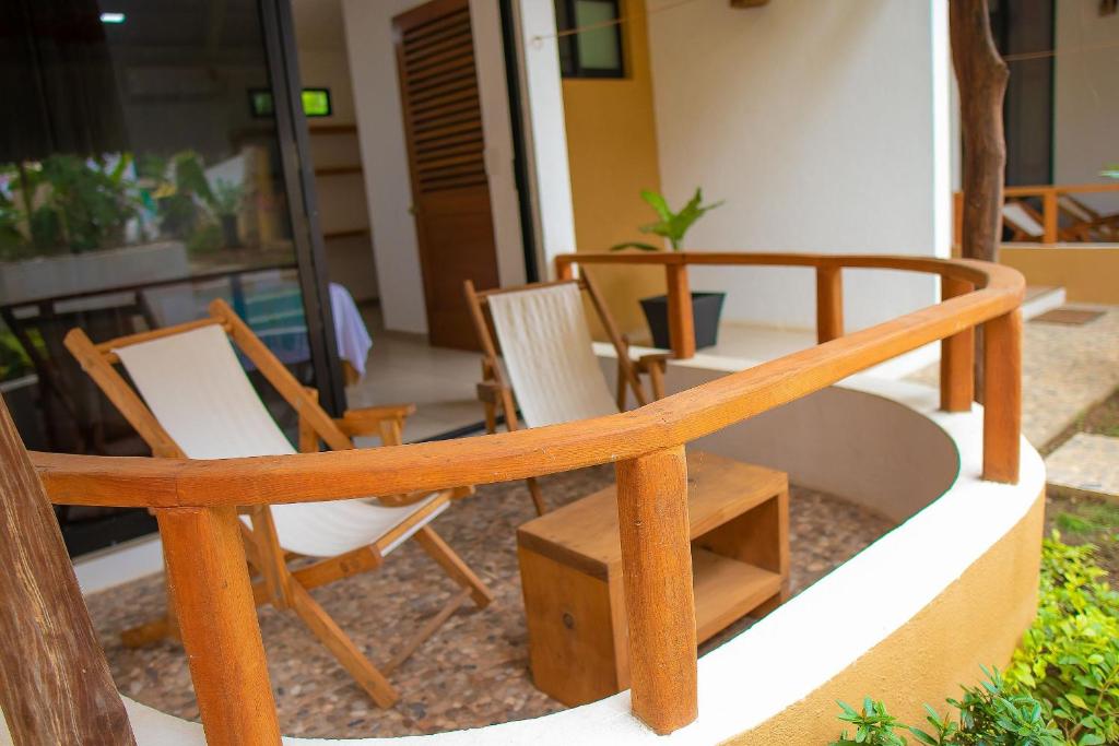 a group of chairs and tables on a porch at Casa Yoo Bigu Mazunte in Mazunte