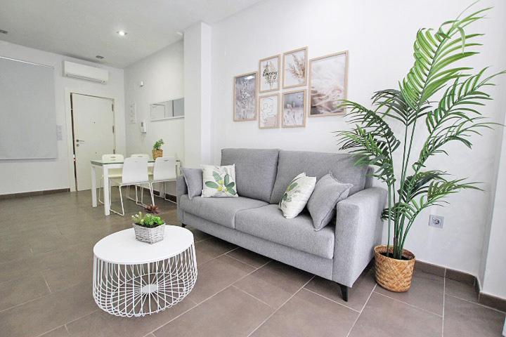 a living room with a couch and a table at Apartamento Bajo 1 Marjal playa centro de Guardamar in Guardamar del Segura