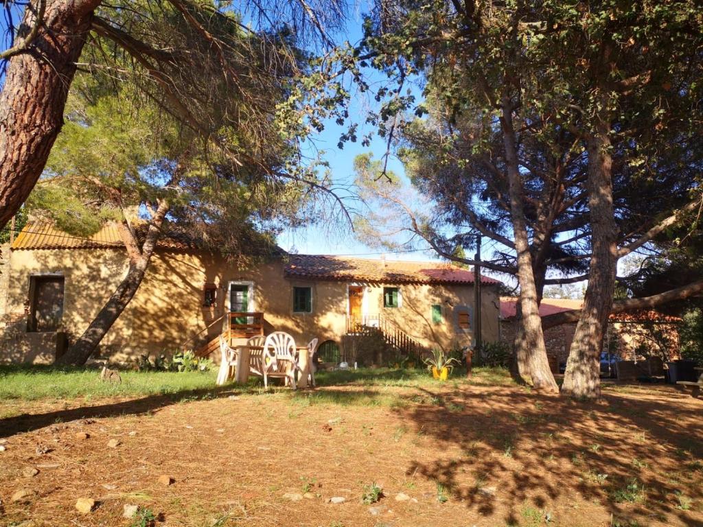 a house with trees in front of it at Maison Entière Hameau Monastir del Camp in Passa