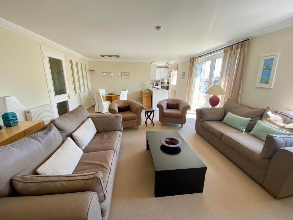 a living room with a couch and a coffee table at Golf Court View, Elie in Elie