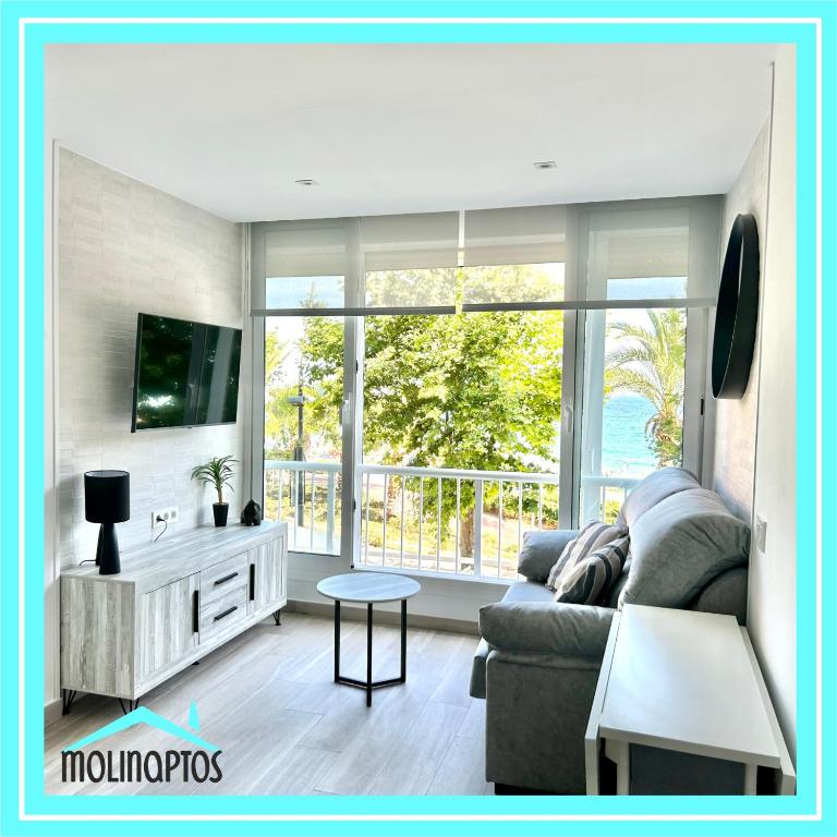 Hotel Estudio 29 Frente al Mar by Molinaptos, a living room with a couch and a large window at Estudio 29 Frente al Mar by Molinaptos in Benidorm