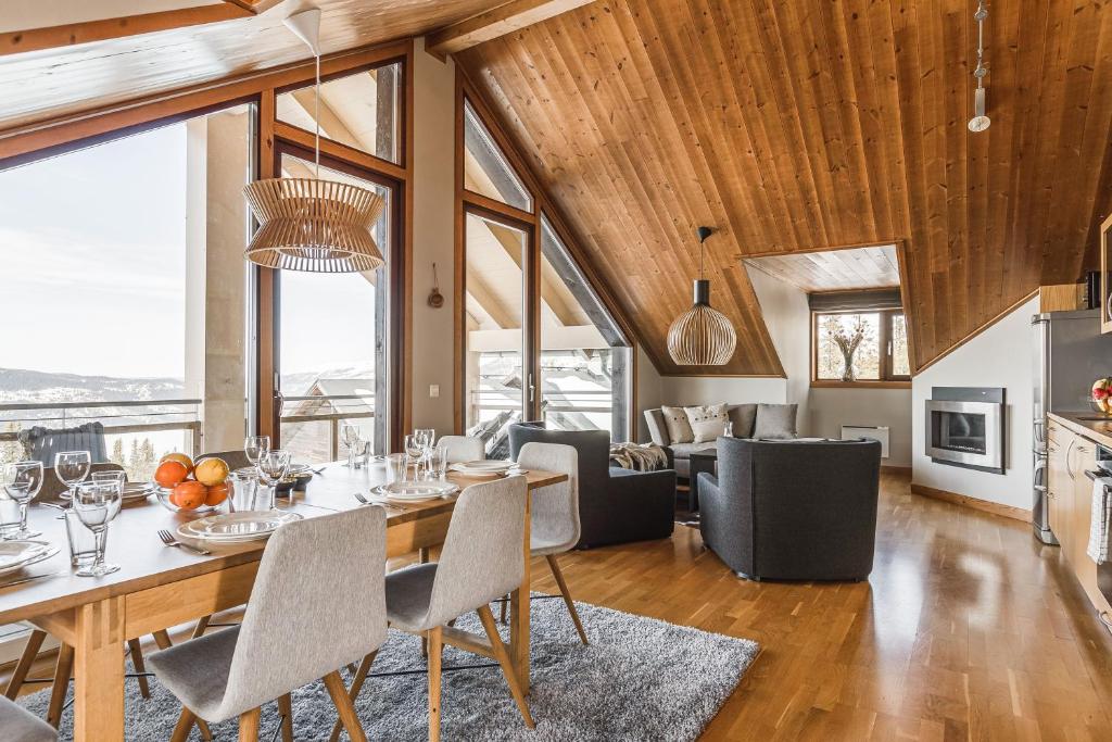 a dining room and living room with a table and chairs at Åre's best family home in Åre
