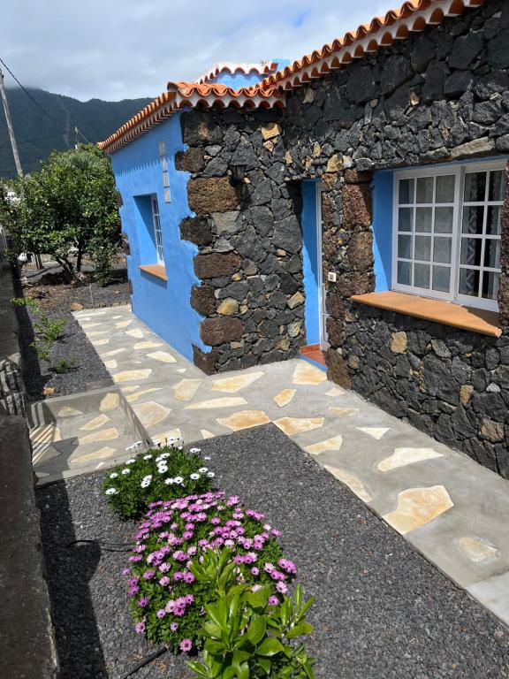 a blue house with flowers in front of it at Casa La Era in El Paso