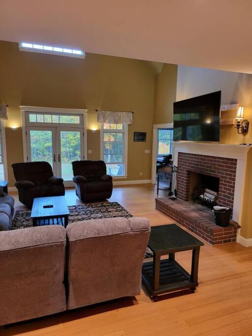 a living room with two couches and a fireplace at 5 Bedroom Bethel Maine home in Bethel