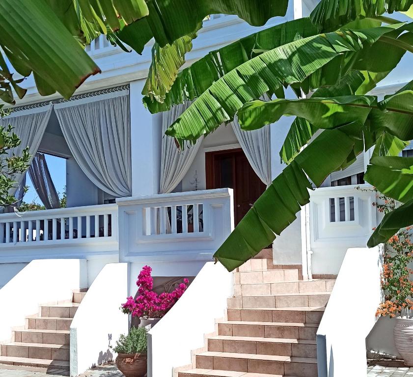 a white house with stairs and plants at Sweet home #chania in Perivólia