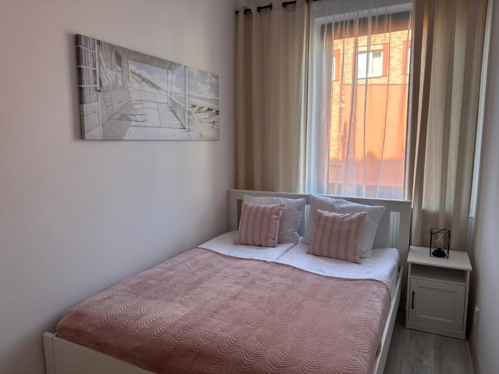 Postel nebo postele na pokoji v ubytování Apartamenty Przy Deptaku