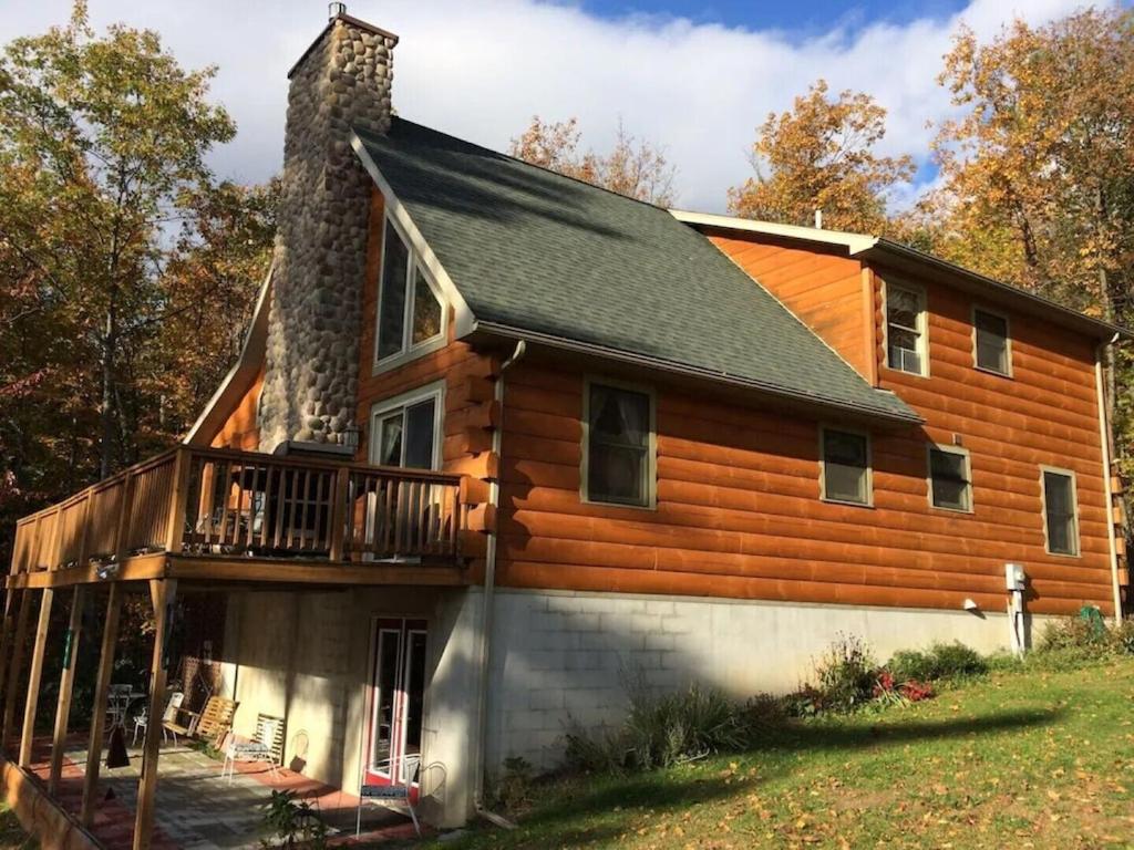 a log cabin with a porch and a balcony at Beautiful Log Home, Lake side. in New Hope