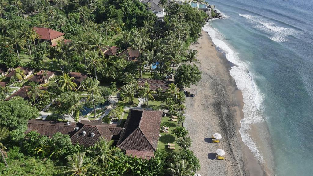 an aerial view of a resort on the beach at Hidden Paradise Cottages in Amed