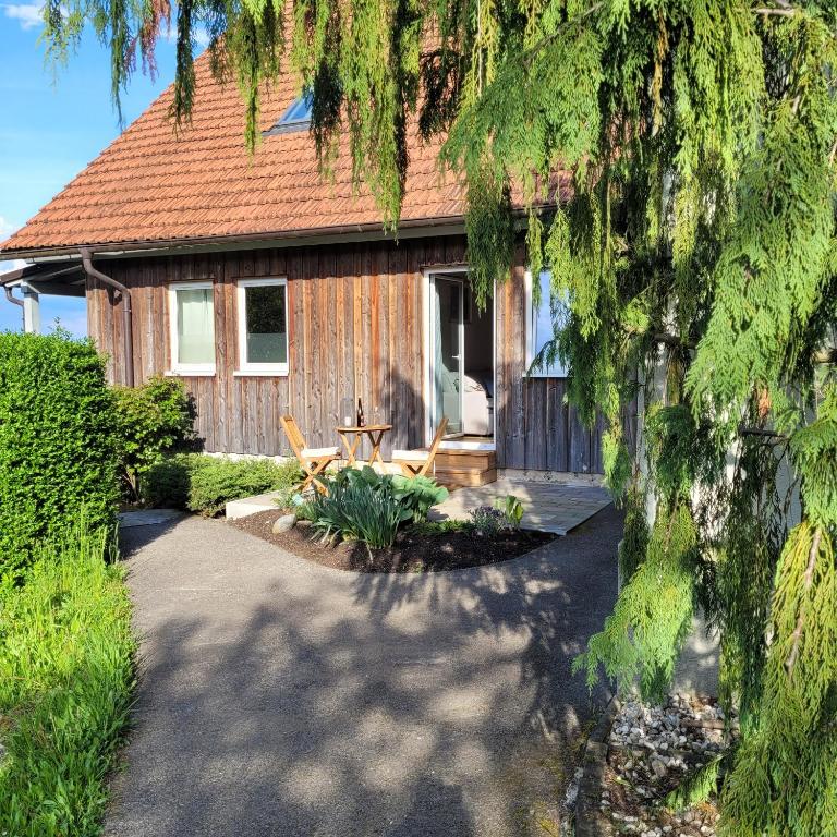 a house with a table and chairs in front of it at Kuschelige Maisonette in Lannach