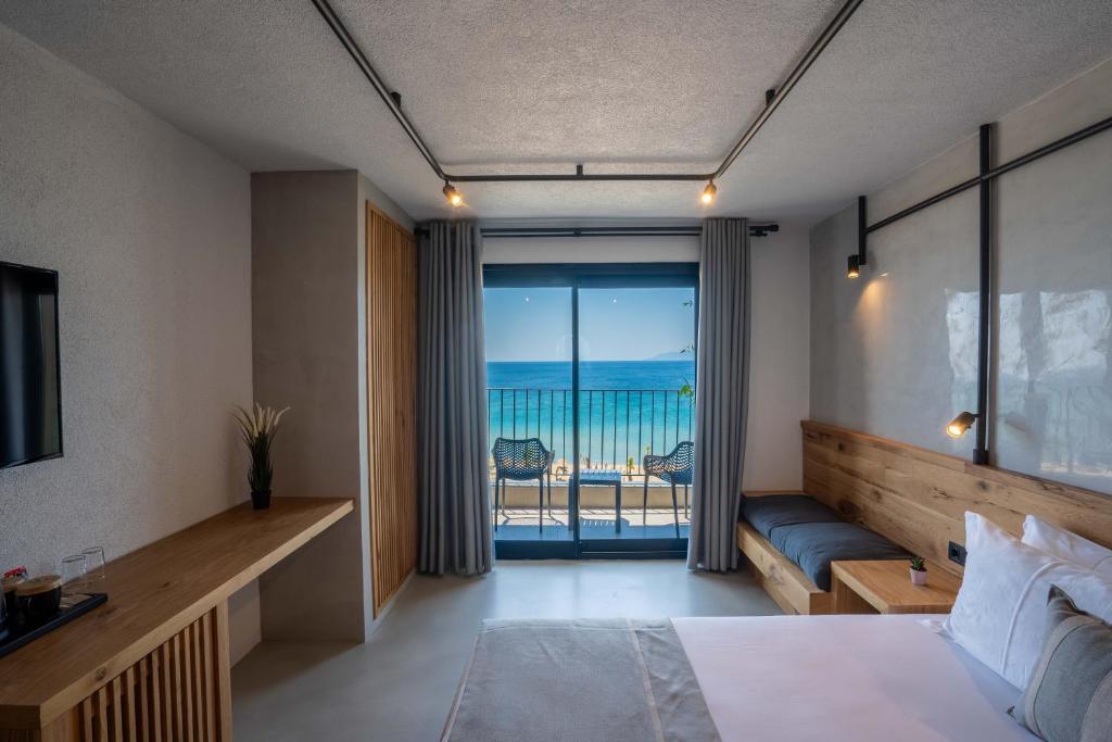 a bedroom with a bed and a view of the ocean at Ayvalık Sea Long in Ayvalık