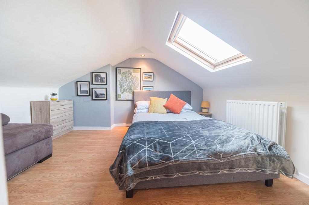 a bedroom with a bed and a skylight at WhereToStay Entire 2bed House in Barrow in Furness