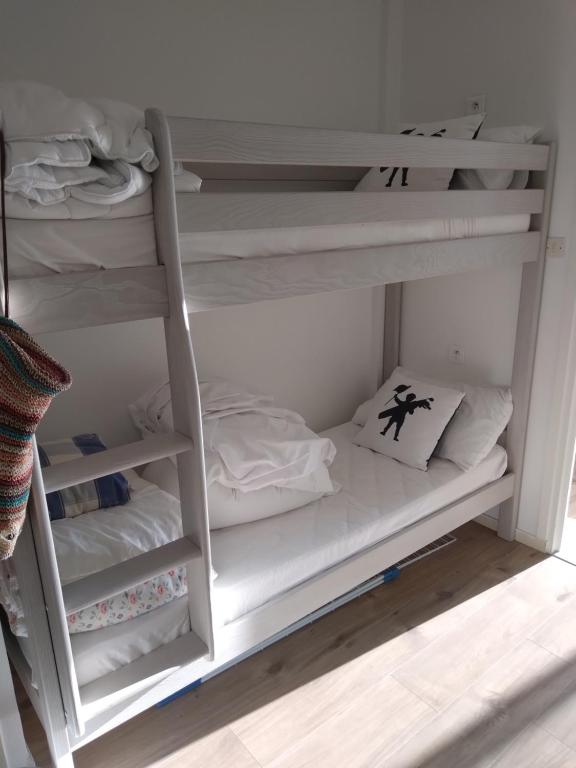 a white bunk bed with two mattresses at Magnifique studio double cabine in Le Touquet-Paris-Plage