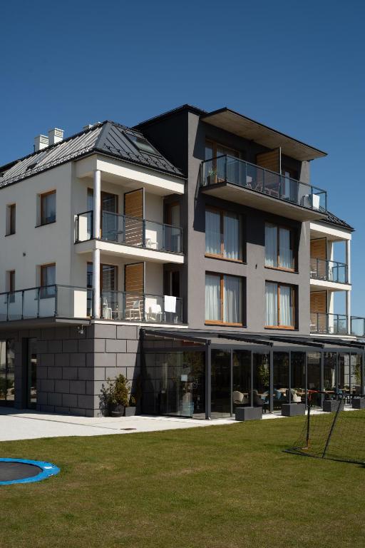 a large building with a lot of windows at Morski Apartament in Sarbinowo