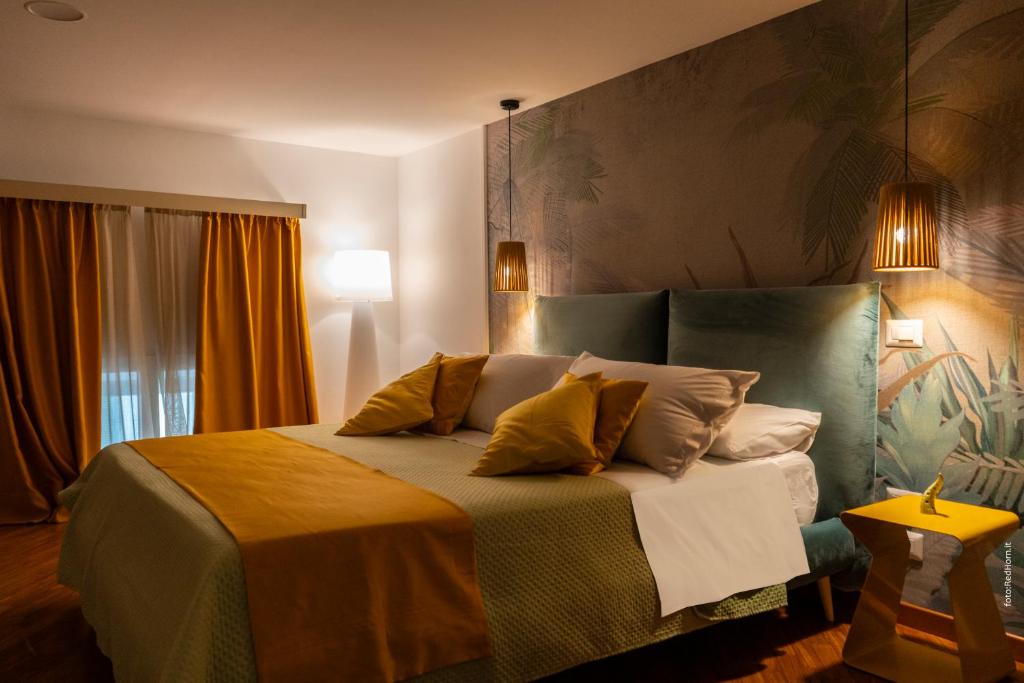 a bedroom with a large bed with pillows on it at Two Rooms Chiaia 37 in Naples