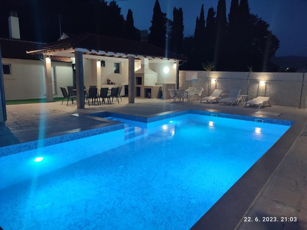 a swimming pool in a backyard at night at Villa Jelena in Trebinje