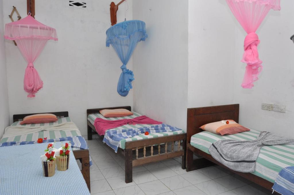 Postel nebo postele na pokoji v ubytování Marshal Beach Guesthouse