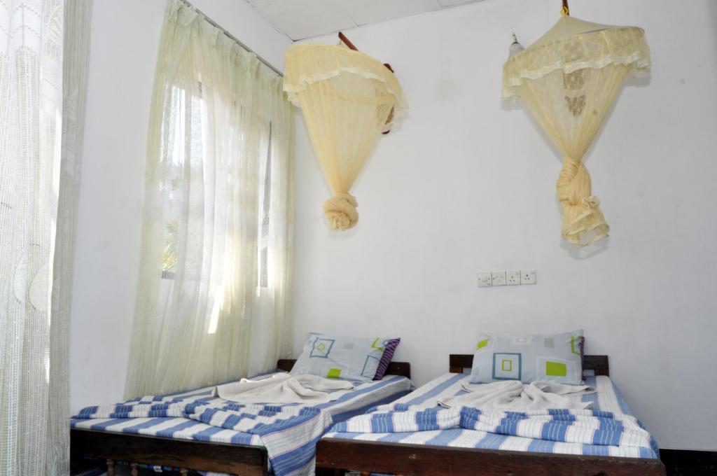 Postel nebo postele na pokoji v ubytování Marshal Beach Guesthouse