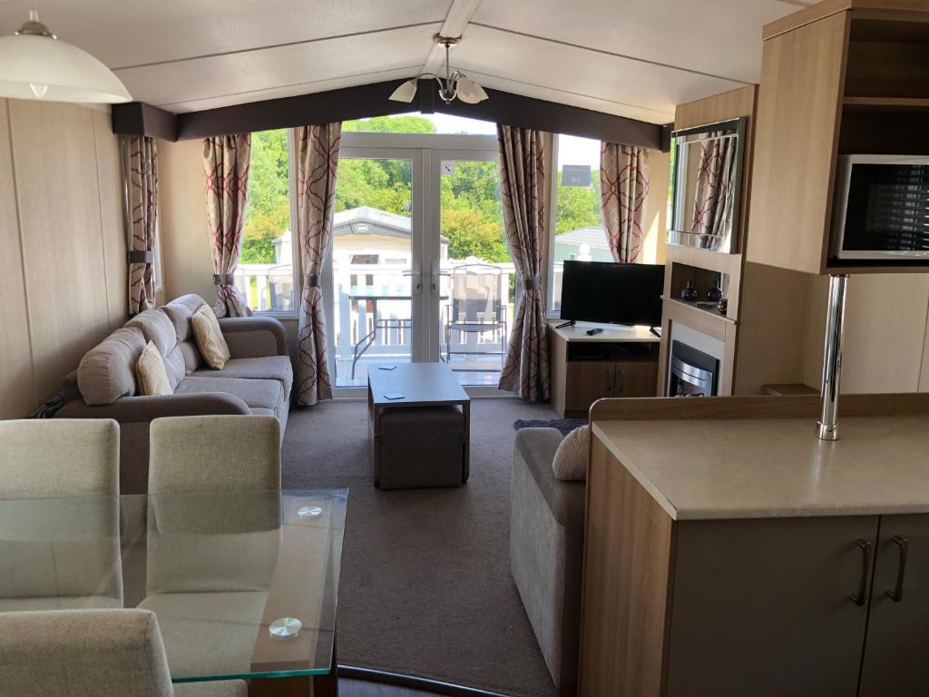 a living room with a couch and a tv at Popular property in Bembridge in Bembridge