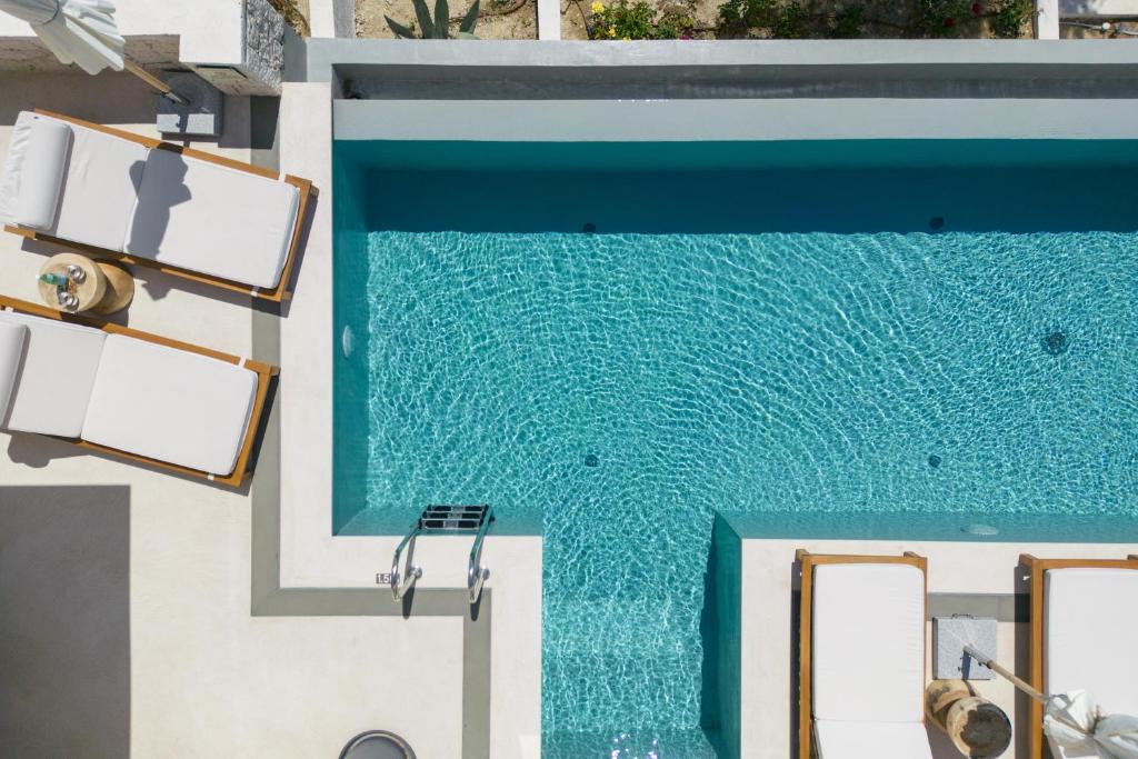 a swimming pool next to a building at Sun n Salt Private Villas in Agios Georgios Pagon