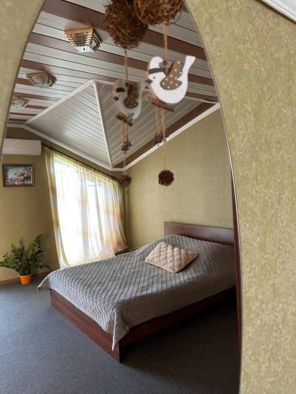 a bedroom with a bed and a mirror at Міні-готель in Kotowsk